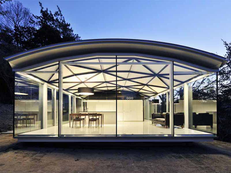 Steel Truss この住宅は、山間の自然木を残した傾斜地に建つ。場所性のもつポテンシャルから、樹木をイメージするオーガニックな意匠性と構造体が連続するような空間を考えた。そして、この大きなスチールトラスの大屋根を、サニタリースペースと茶室に見立てたゲスト室の2つのモノコック構造のスチールボックスが支えている。<br />四畳半のこの鉄の茶室は、厚さ6mmのスチールプレートで一体成型され、運搬、板材の規格寸法、溶接等を複合的に考慮して、ヴォリュームを決定している。ほこらのようなプライベート性の高いこの茶室のトップライトを開放すると、ダイレクトに自然の気配が侵入する中庭空間へと反転し、閉鎖性は一気に開放される。 開口部を構成する要素を視線からなくし、ピクチャーフレームで切り取ったエッジのディテールによって、自然の揺らぎの変化がより敏感に五感に作用し、意識を無限に開放する空間を期待した。<br /><br />設計するにあたり、鋼構造を選択した理由をひとことで言えば、材料の確かさである。高強度や高耐久性はもちろん、鉄の加工技術の発展で変化自在であり、加工精度の正確さ、そして、建築パーツのプロダクト的な工場制作が可能である。またさらに、現場施工の簡略化、素材自身のクオリティやコスト面など総合的に捉えれば、私自身、最も信頼のおける、優れものの建築材料であると考えている。<br />今後、鉄を用いてつくってみたい空間は、従来の柱、梁の規制に捉われない、構造から解き放たれた建築。たとえば、モノッコック的な建築の試みの、船や車、乗り物のような面で包まれた大空間であり、その無限の可能性に魅力を感じている。一方で、無機質なクールな素材であるが、自然や五感に連動した空間を目指したい。